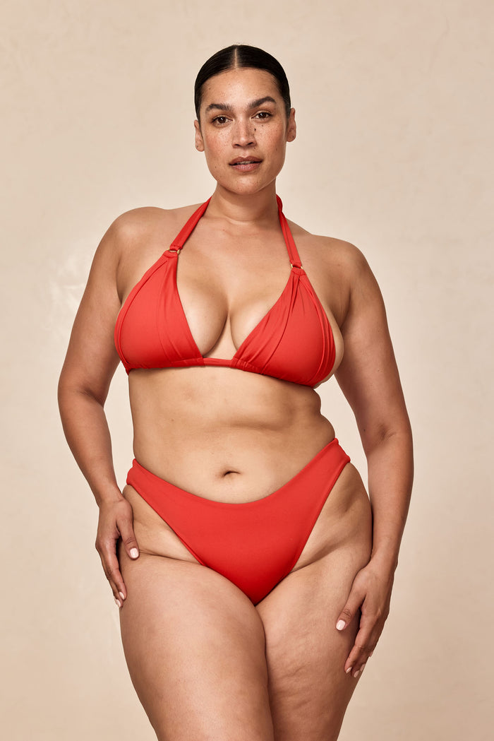 Front view of Seychelles Bottom in Chili Pepper Crinkle showcasing modest coverage on curvy model against beige background