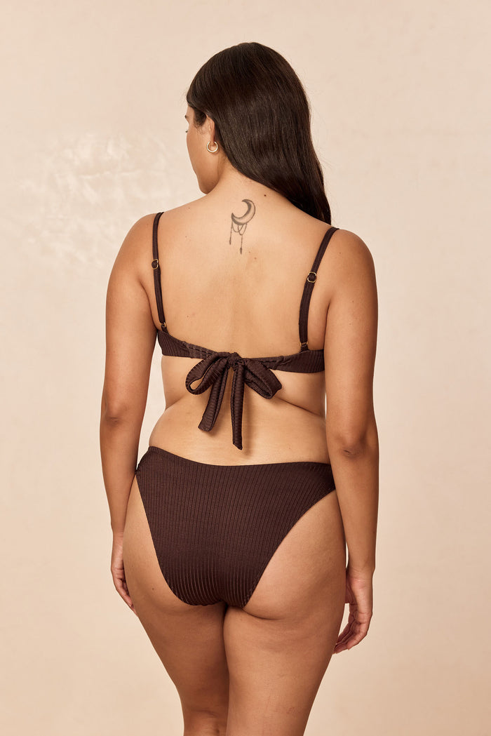 Back view of Seychelles Bottom in Espresso Wide Rib showcasing modest coverage and wide rib texture on neutral beige background