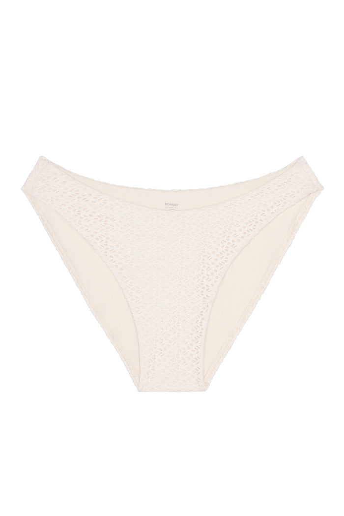 Front view of Seychelles bottom in ivory crochet showing modest coverage and textured crochet overlay on white background