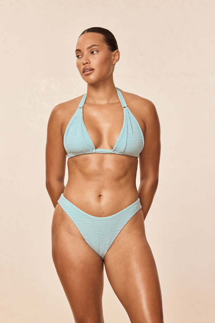 Front view of Seychelles bottom in Light Slate Crinkle showing high-cut V-front and textured crinkle fabric on beige background
