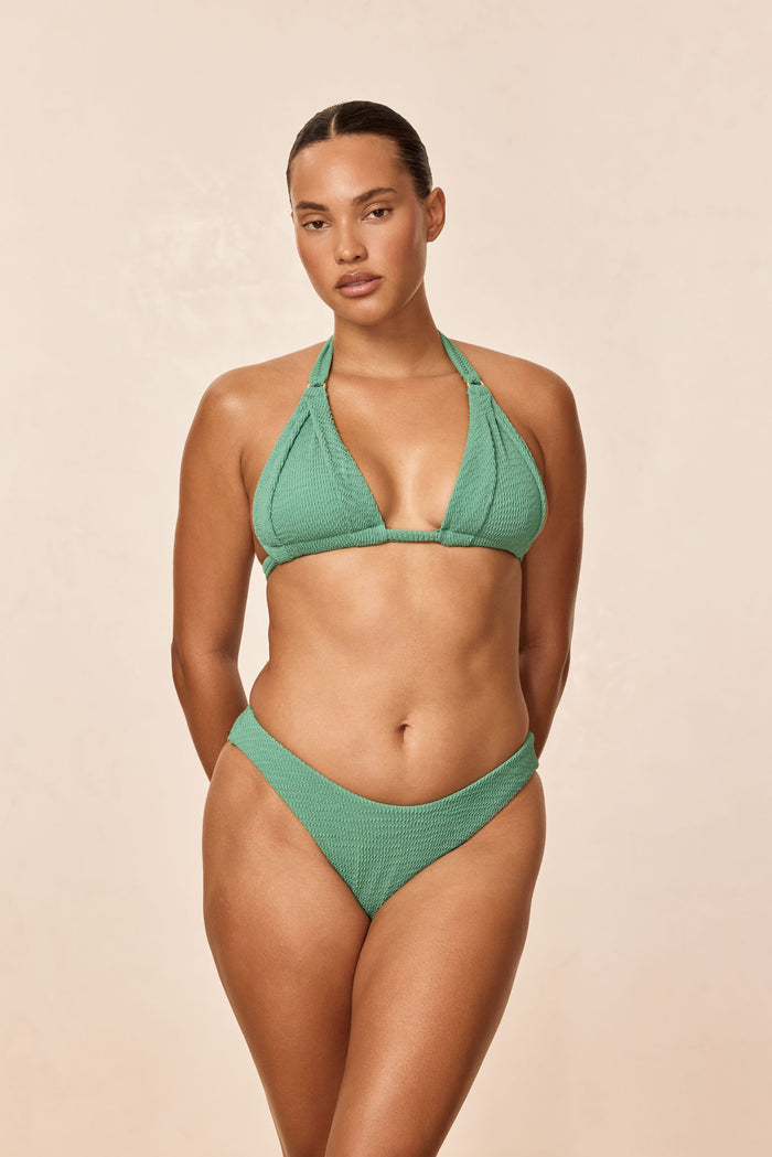 Front view of Seychelles Bottom in Pond Crinkle green showing modest coverage and textured crinkle fabric on a neutral beige background