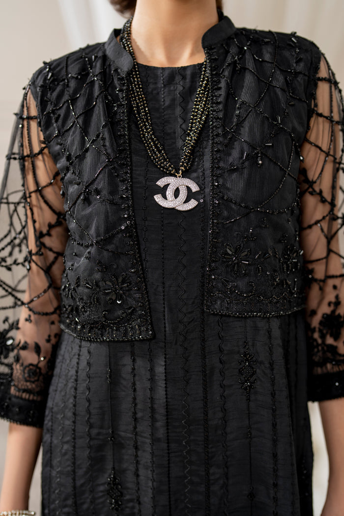 Close-up of naqshi siara cropped jacket sleeve cuff featuring dense net embroidery, crystals, beads & hand‑made hangings.