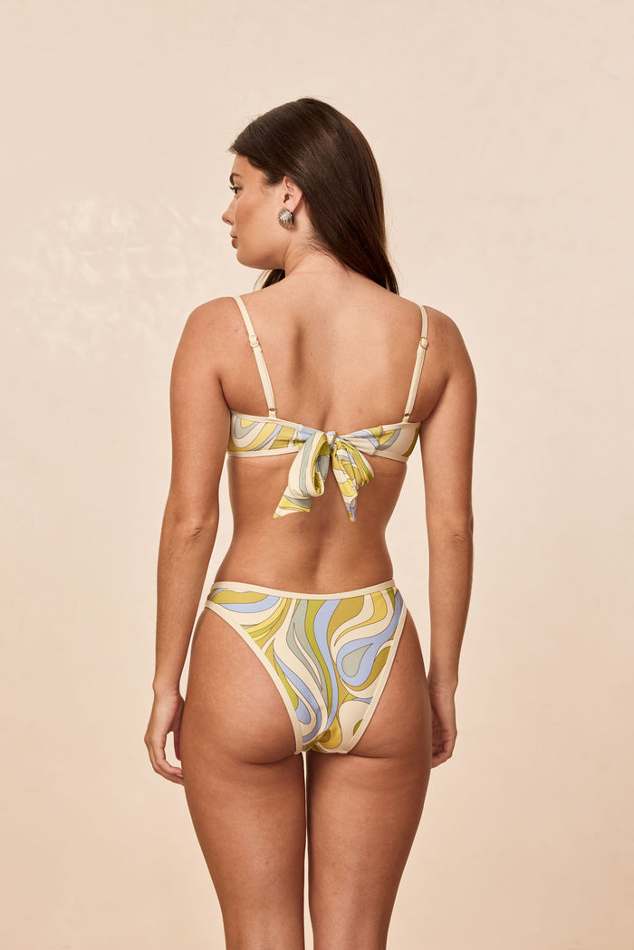 Rear view of Somerset Bottom in Costa Rei Apple/Ivory, high-rise cheeky cut with yellow-blue swirl print on beige background