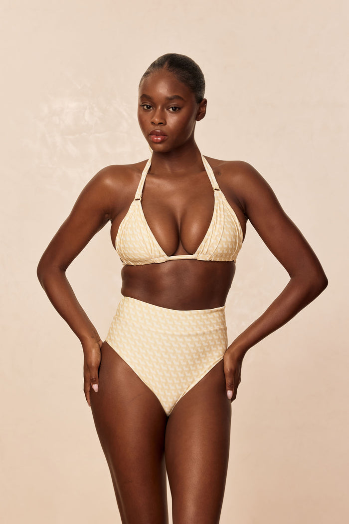 Front view of Sorrento Bottom in Ivory Geo on model showcasing high-waisted fit and moderate coverage, neutral beige background