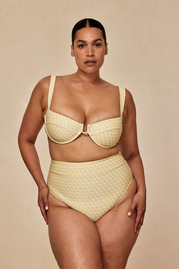 Front view of Sorrento Bottom in Ivory Geo on model showing high-waist fit and matching underwire top on beige background