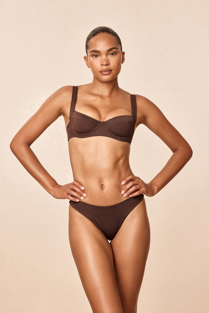 Front view of Sorrento Top in Espresso on model; demi underwire cups, adjustable straps and tie-back with neutral background