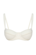 Cream balconette bra with underwire and thin adjustable straps, front view on white background.