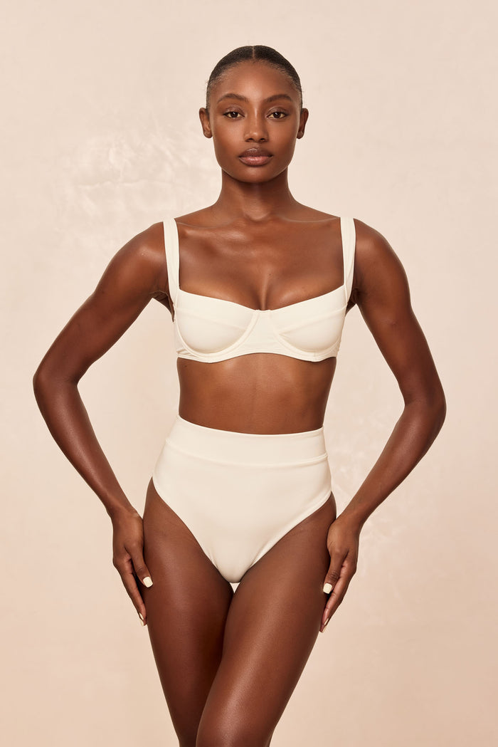 Front view of Sorrento Bottom in ivory on model, high-waisted fit showing moderate coverage against a neutral background