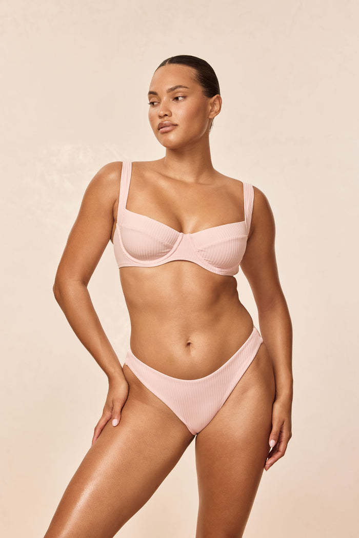 Front view of Sorrento Top in powder pink rib with underwire, square neckline and wide straps on a model against a neutral background