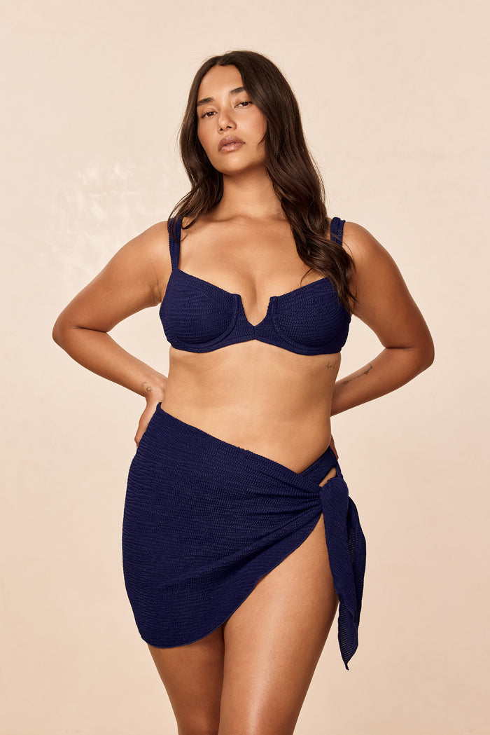 Front view of St. Barth's Skirt in Midnight Crinkle showcasing knit sarong wrap with side tie and high side slit on model