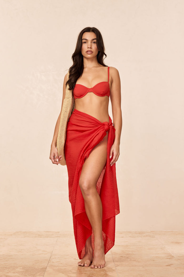 Front view of St. Tropez sarong in Chili Pepper red on model showing crinkle linen texture and high slit