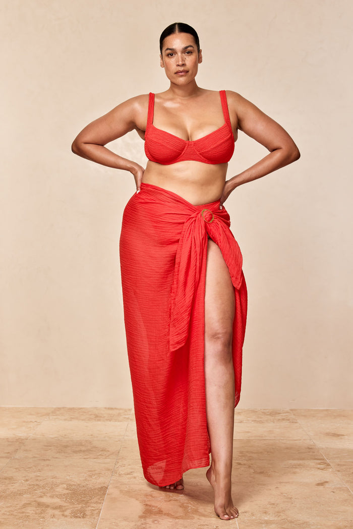 Front view of St. Tropez Sarong in Chili Pepper crinkle linen showcasing thigh-high slit and front ring tie on neutral backdrop