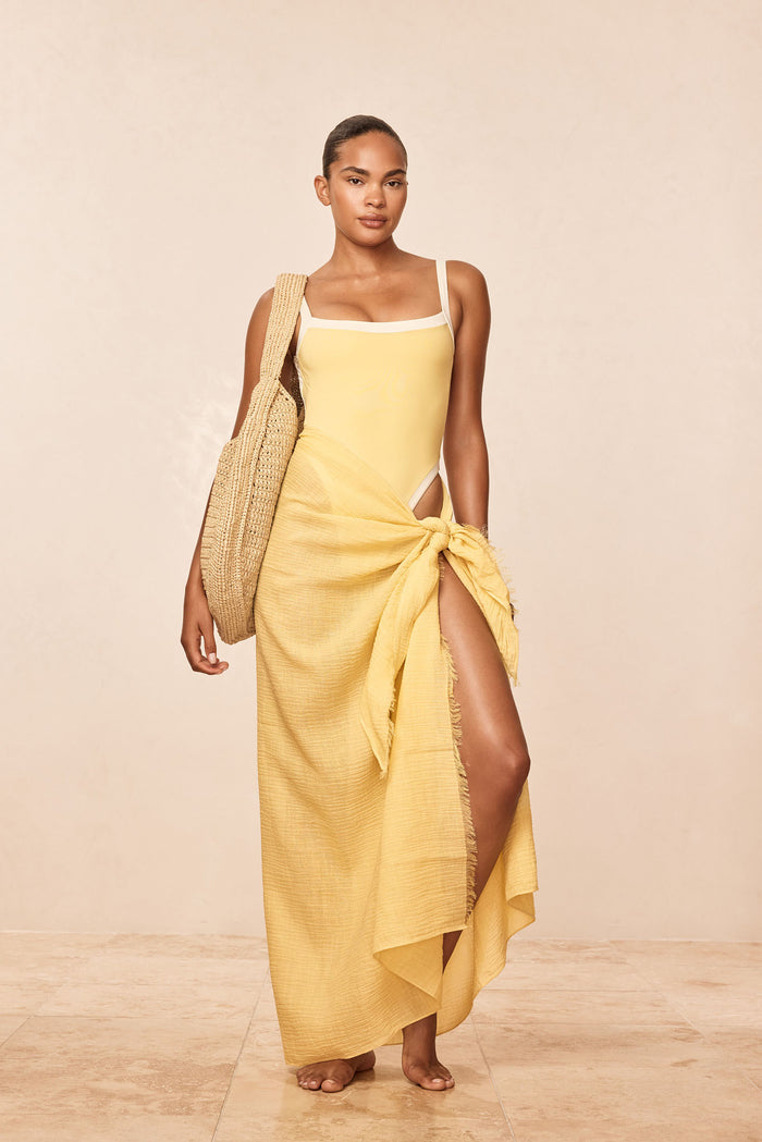 Front view of St. Tropez Sarong in Meyer crinkle linen showcasing adjustable raw edge and semi-sheer fabric tied at the hip with a neutral studio background