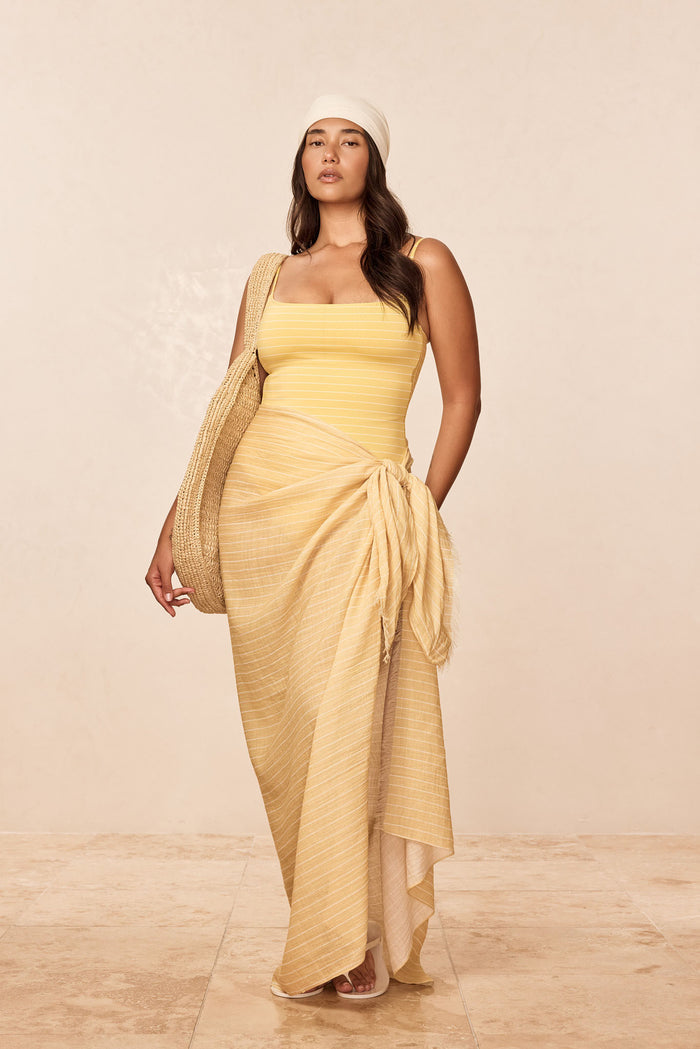 Front view of St. Tropez sarong in Meyer Stripe crinkle linen showing adjustable semi-sheer wrap tied at hip on model with neutral backdrop