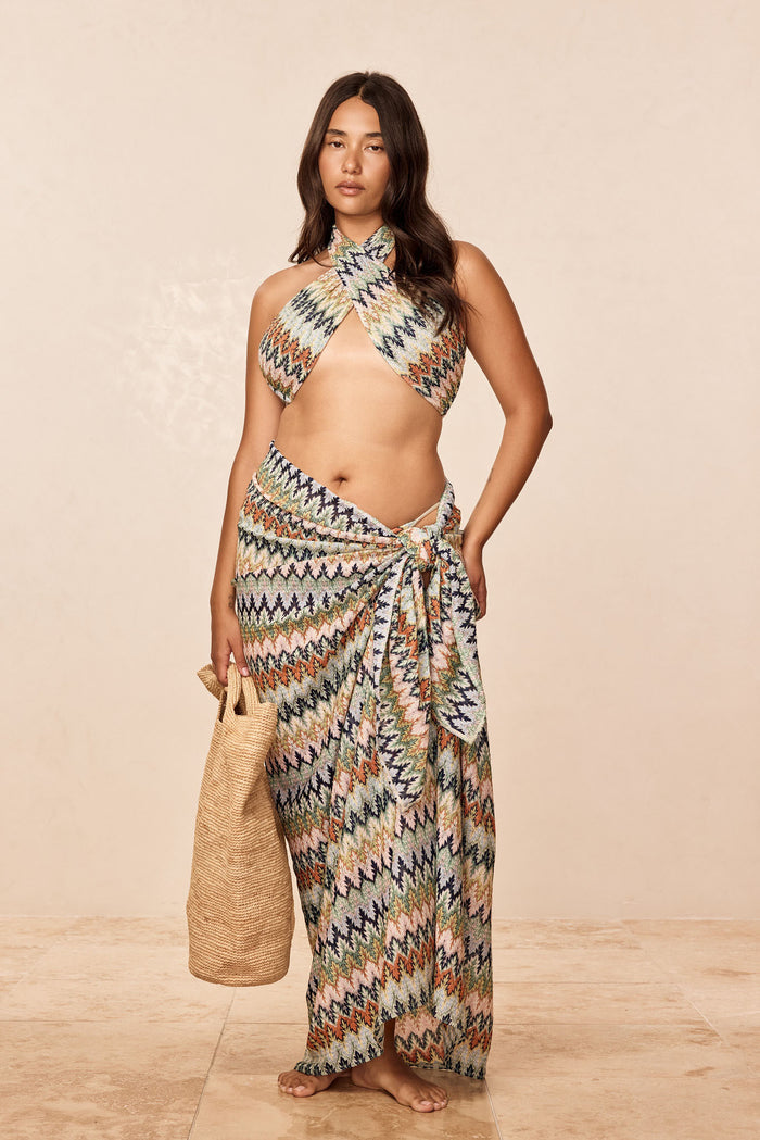 Front view of St Tropez sarong in Porto Cervo Multi showing tie-waist wrap and multicolor zigzag print on a model against a beige studio background