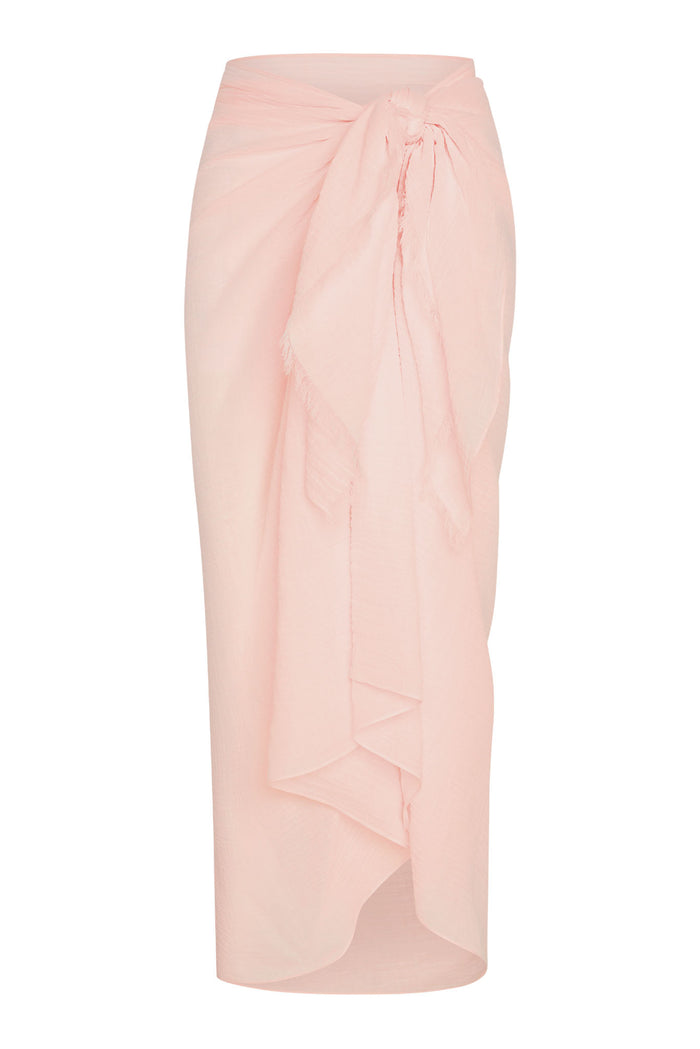 Front view of St. Tropez Sarong showcasing tie-front knot, draped wrap and raw edge in powder pink on white background