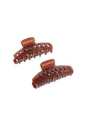 Top-down view of two Staniel Cay medium brown acetate hair clips showcasing engraved gold MONDAY logo on top tabs against a white background