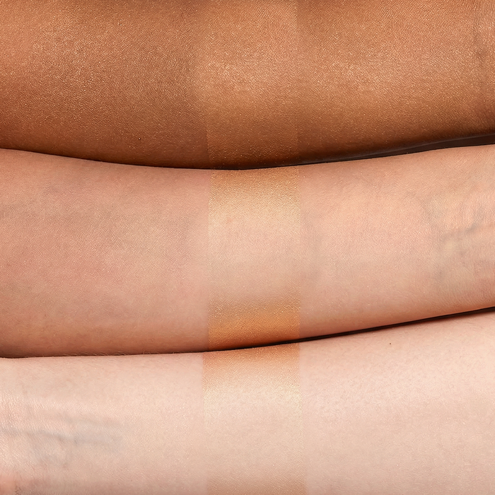 Warm golden illuminating sunscreen swatch on light, medium, and deep skin tones
