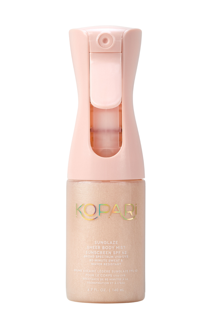 Front view of Kopari Sunglaze Sheer Body Mist Sunscreen SPF 42 bottle showing pink spray top and shimmery rose-gold liquid on white background