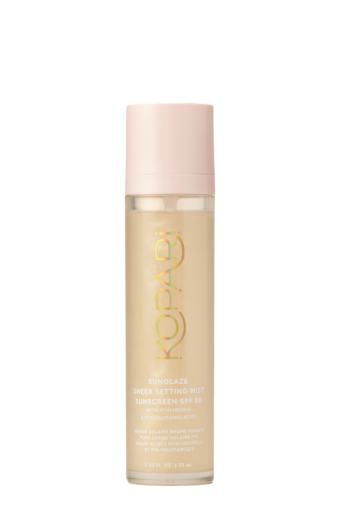 Front of Sunglaze Sheer Setting Mist SPF 50 bottle showing shimmery gold liquid, pink cap and Kopari logo on white background
