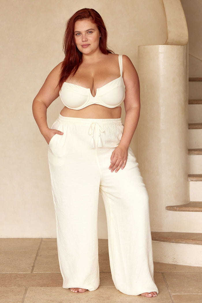Front view of Tahiti Pant in ivory on model showing elastic drawstring waist with tassels and wide flowy legs