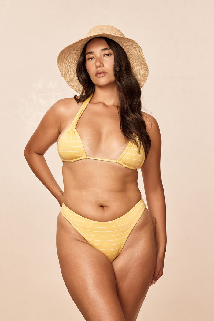 Front view of Tamarama bottom in Meyer Stripe showing high leg cut, thin sides and cheeky coverage on beige background