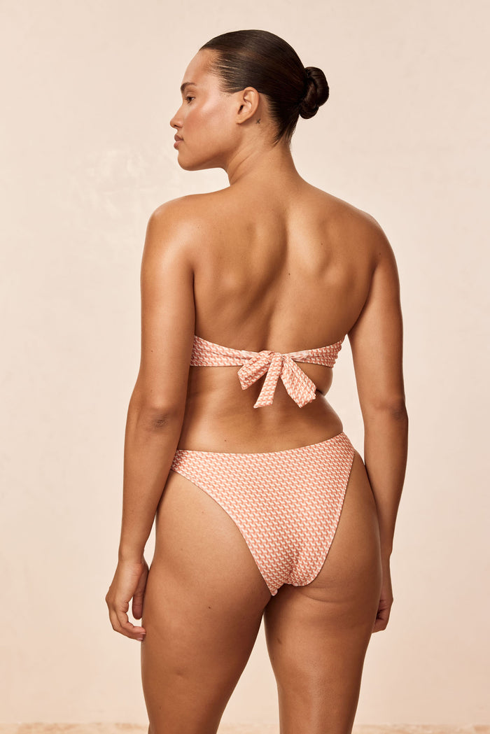 Rear view of Tamarama Bottom in Micro Geo print showing high-cut leg and textured fabric against a neutral studio background