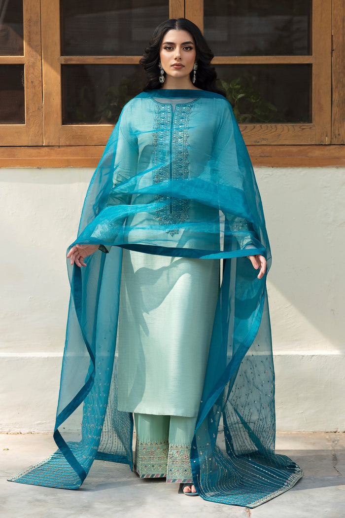 Close‑up of NAQSHI Tania machine‑embroidered raw‑silk culottes featuring monochromatic sequin borders and tonal aqua stitching.