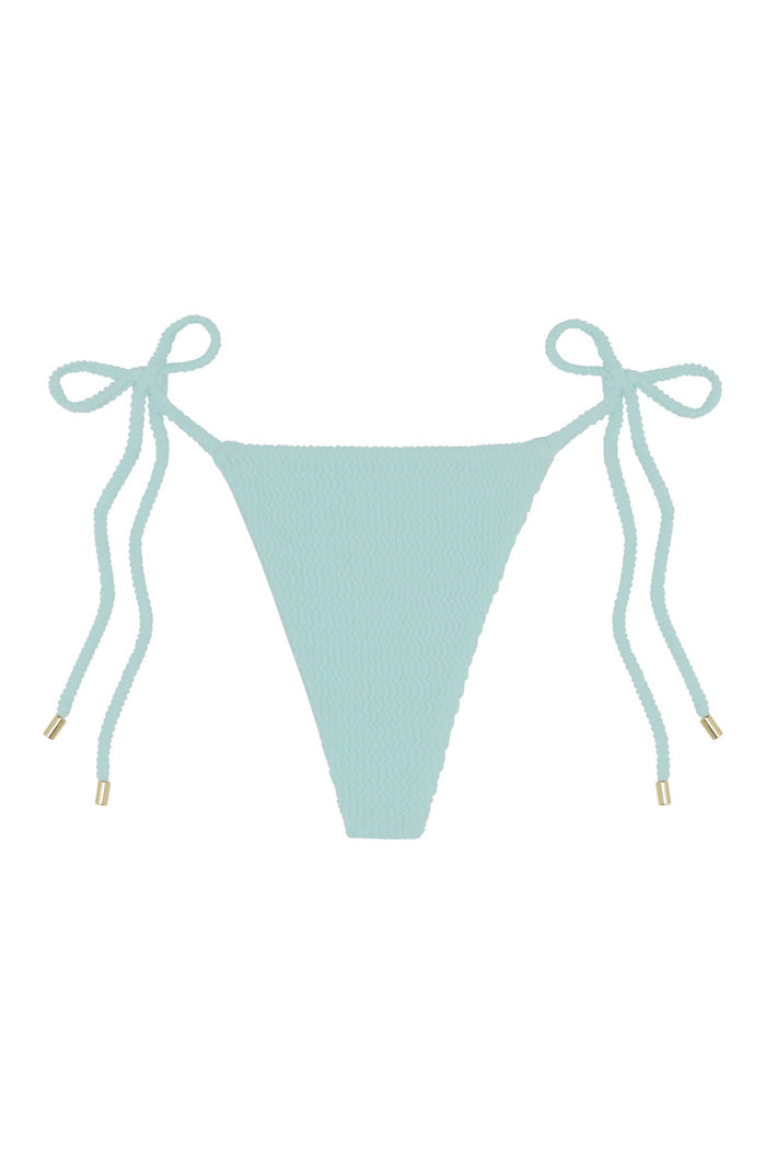Front of Taormina Bottom in light slate crinkle, tie-side bikini with textured fabric and gold-tipped cords on white