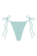 Front of Taormina Bottom in light slate crinkle, tie-side bikini with textured fabric and gold-tipped cords on white