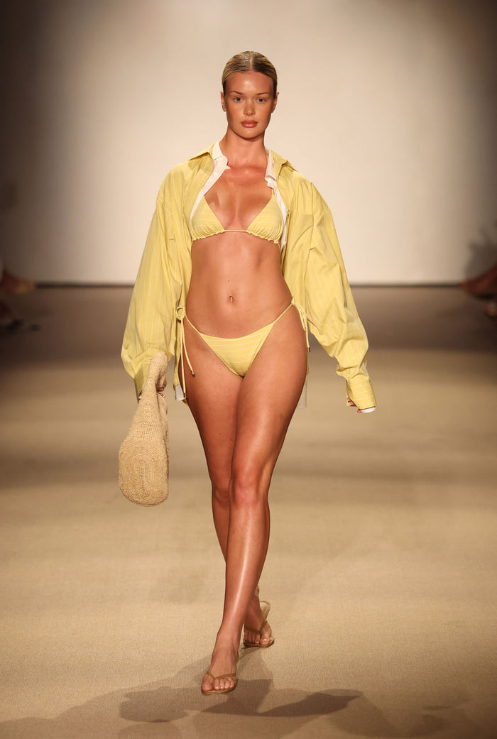 Front view of Taormina Bottom in Meyer Stripe on model showcasing adjustable side ties and dainty straps on runway