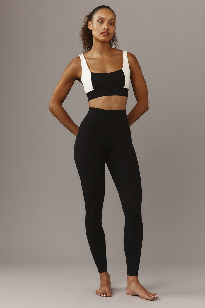 Front view of Tash Bra in Black/Ivory showcasing square neckline, wide white straps and supportive wide underband on neutral background