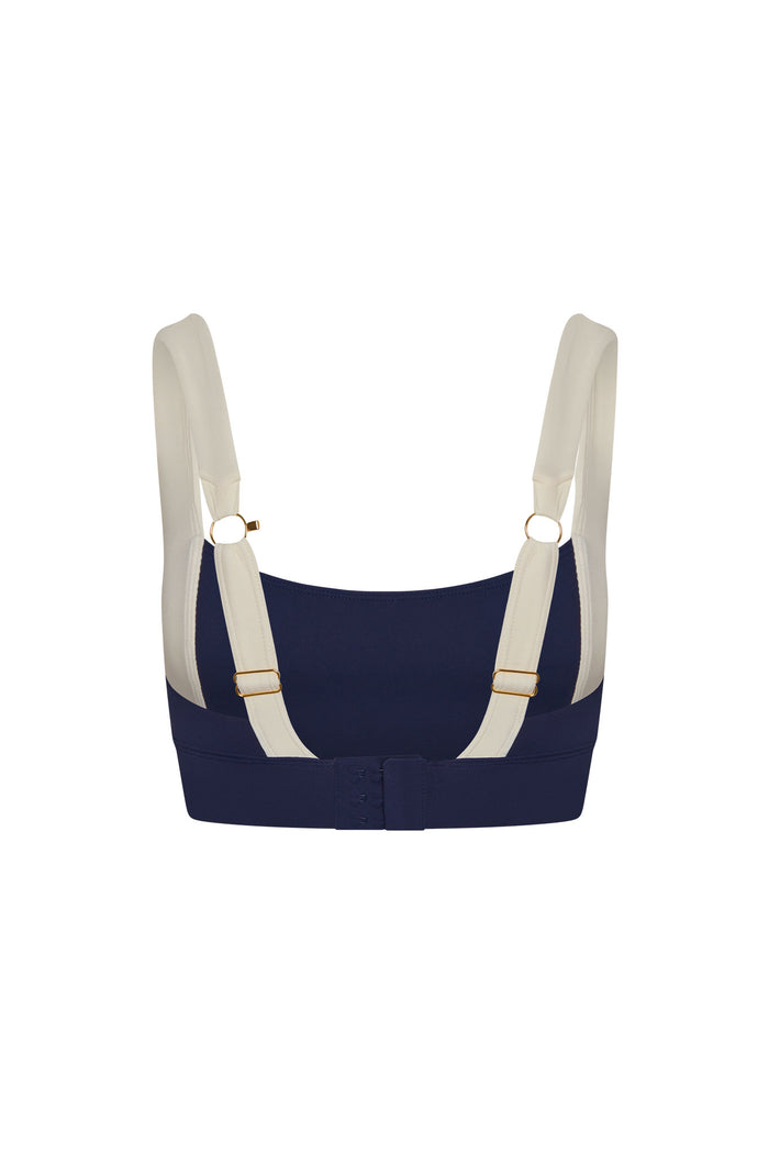 Back view of Tash Bra in midnight and ivory jersey showing contrast ivory adjustable straps with gold rings and hook-and-eye closure on white background