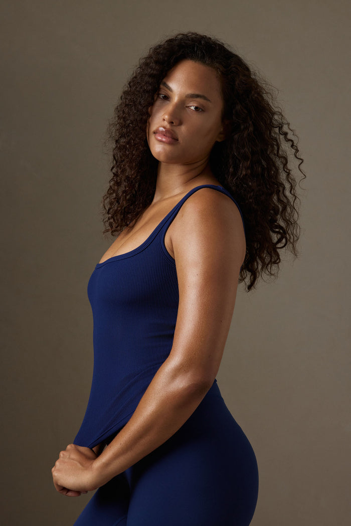 Side view of Tash Tank in midnight thin rib, fitted scoop-neck top showing ribbed texture against neutral background