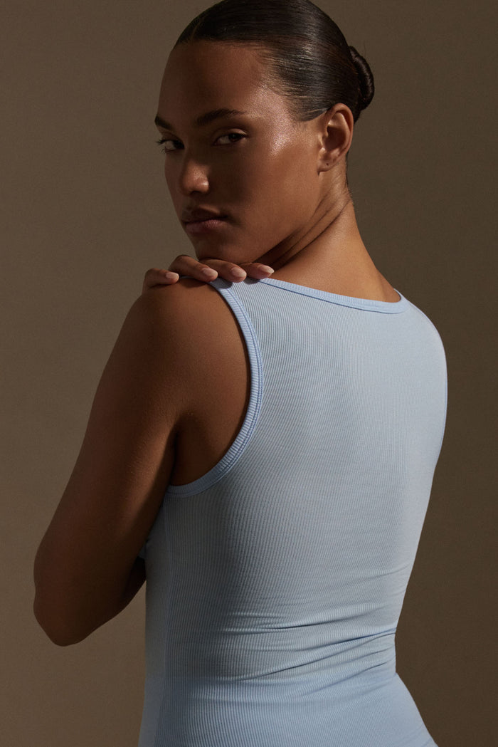 Back three-quarter view of Tash Tank Long in Sky lightweight rib showing ribbed texture and square neckline