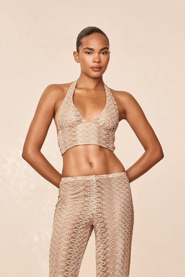 Front view of Toulon Top in Porto Cervo Gold, halter neckline and textured metallic knit on model, neutral background