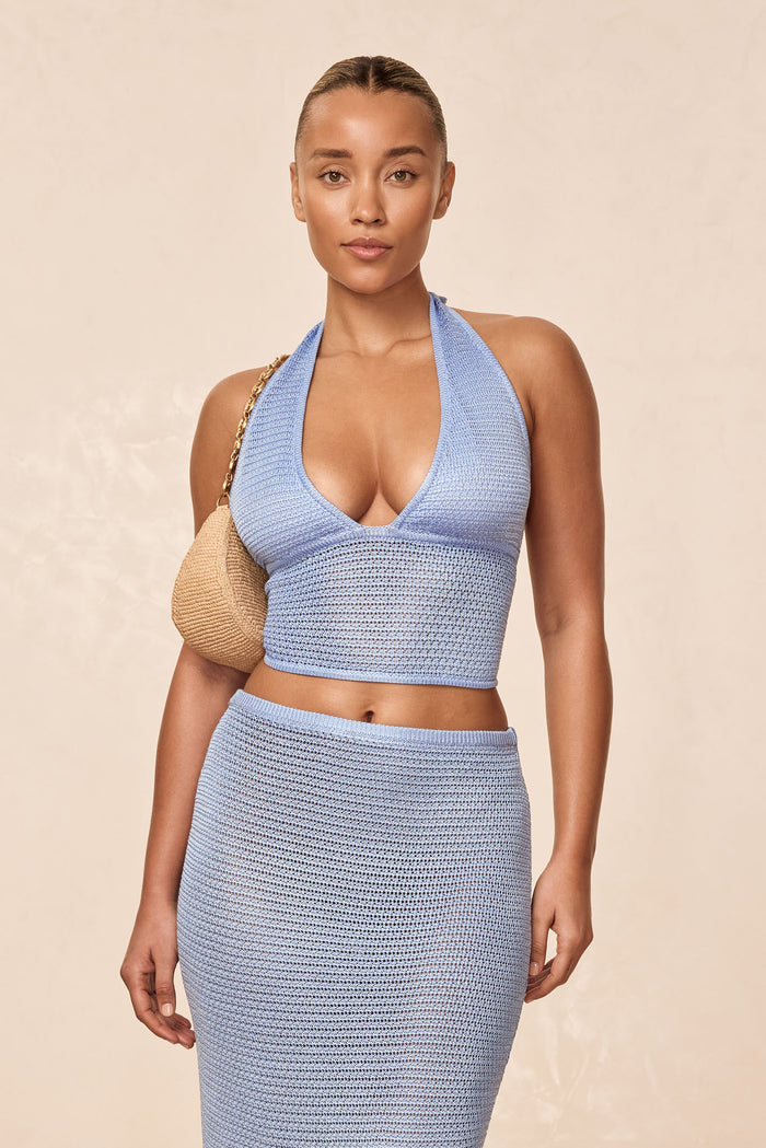 Front view of Toulon Top Lined in sky treble knit with halter deep-V neckline, adjustable ties and cropped crochet fit