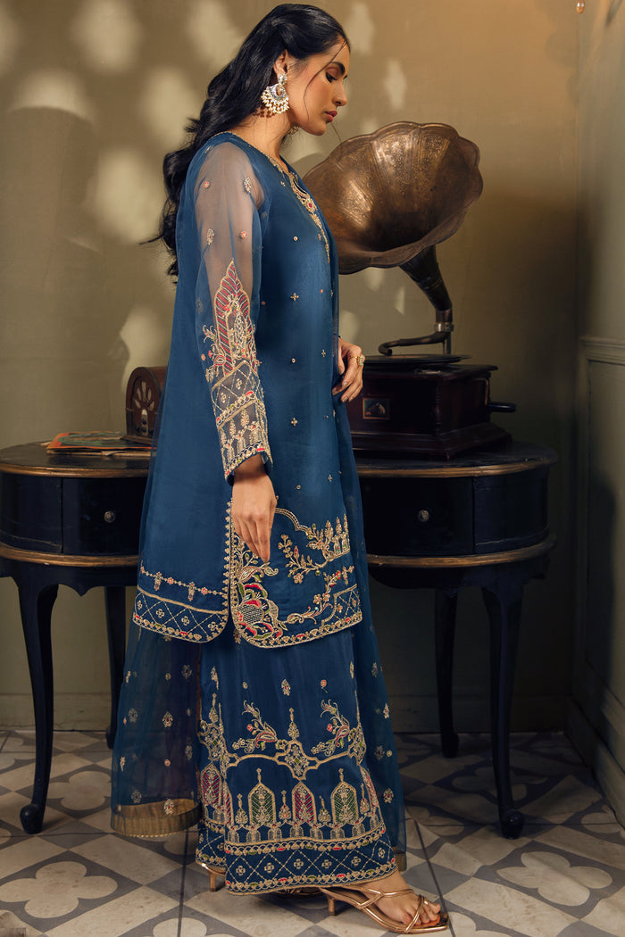 Side view of Tropicana blue embroidered organza shirt showing culottes pants and flowing net dupatta