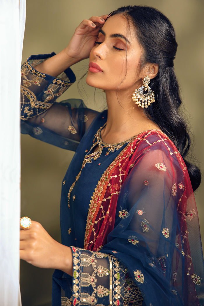 Portrait close up of Tropicana blue formal dress showing sleeve embroidery and dupatta border detailing