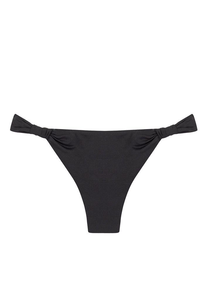 Flatlay of Tulum Bottom in black showcasing knotted side ties and thong cut on white background