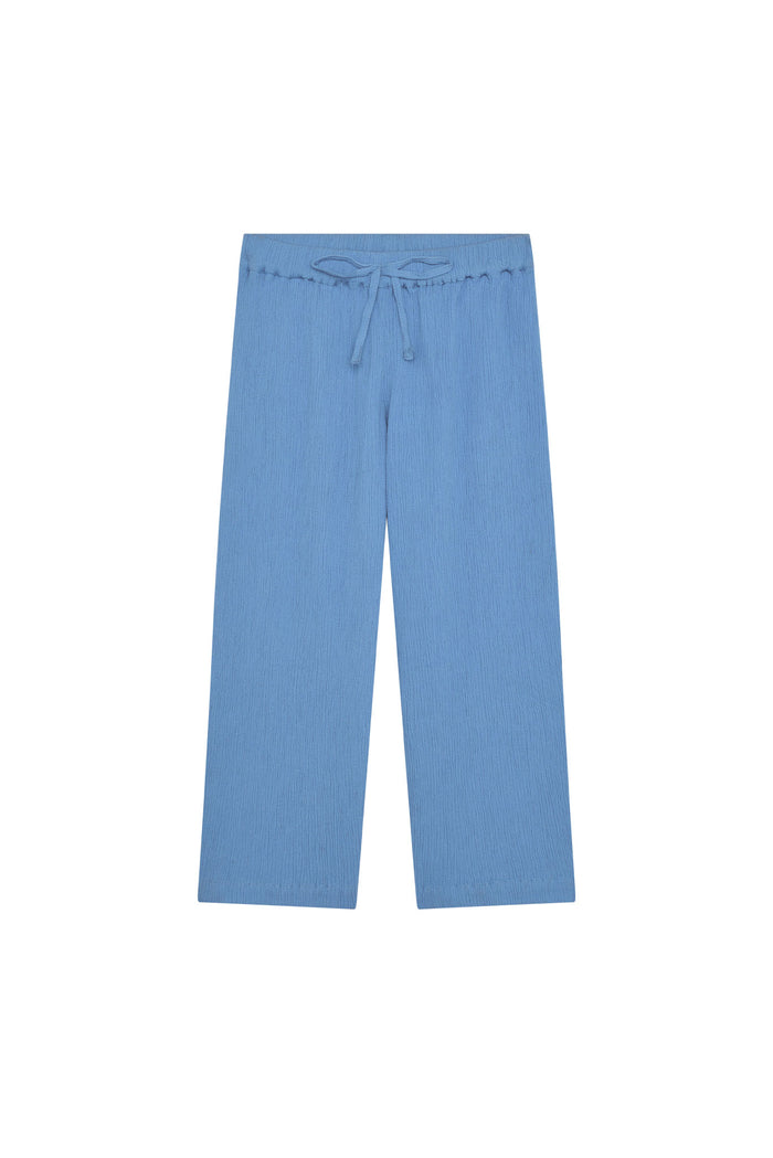Front view of Tuscany Pant Kids in Azure Crinkle with smocked elastic drawstring waistband and wide legs on white background