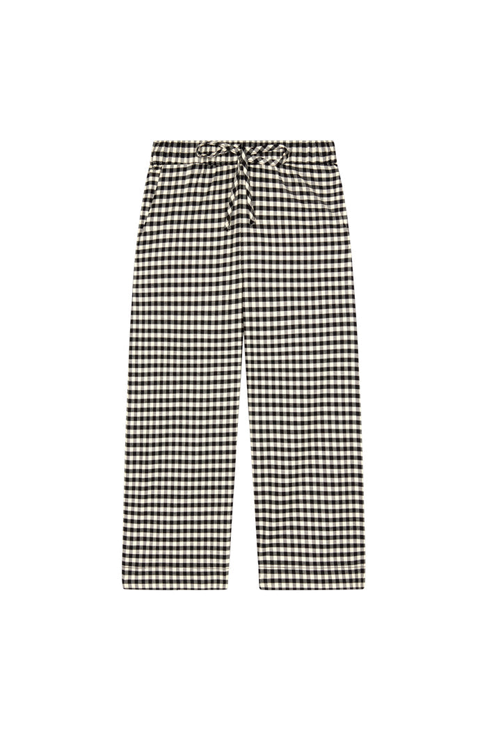 Front view of Tuscany Pant Kids black gingham pants showing smocked waistband, drawstring tie and flare leg on white background