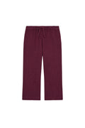 Front flat lay of Tuscany Pants Kids in fig showing smocked waistband, drawstring, crinkle texture and flare leg on white