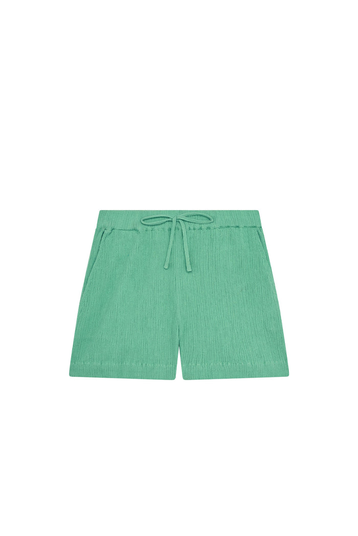 Front view of Tuscany kids shorts in pond crinkle showcasing elastic waist faux tie and side pockets on white background