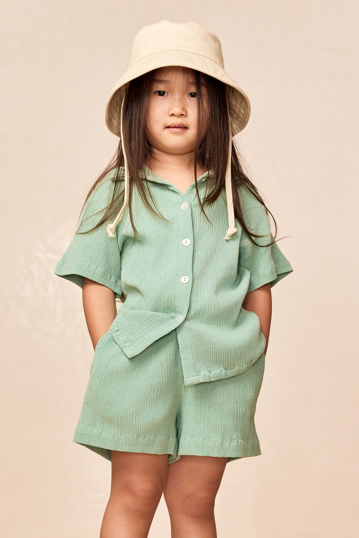 Front view of Tuscany Short kids in Pond Crinkle showing crinkled fabric, elastic waist and pull-on shorts on child model