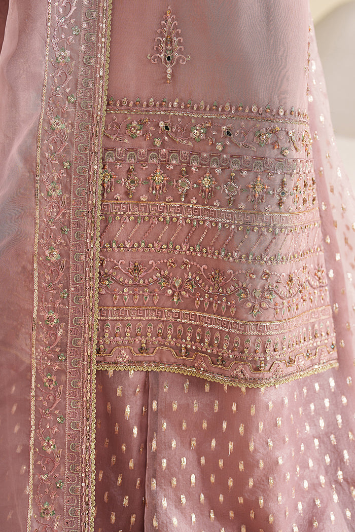 Close-up of NAQSHI blush pink dress showing fine embroidery and detailed fabric work