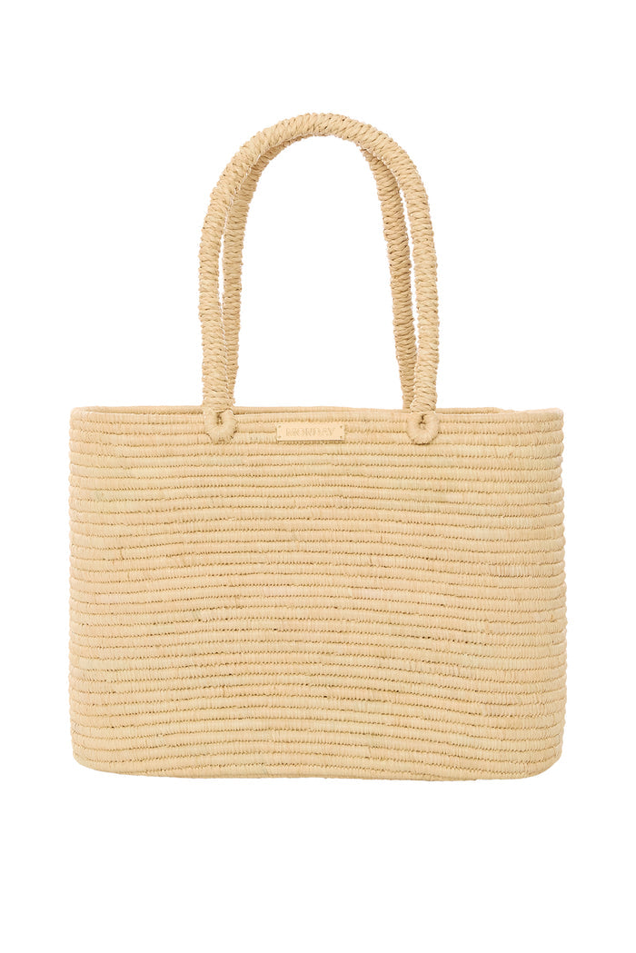 Front view of Valencia Bag Large showcasing woven raffia texture, braided handles, and gold MONDAY plaque with white background