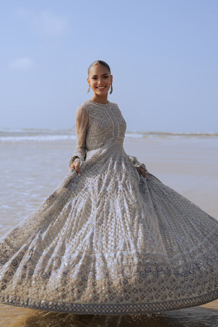 Rear view of NAQSHI Valeria frock showing hand‑embroidered mini motif spray across the back pantaloons, heavy embroidery continuing from bodice, and clean back sequin border.