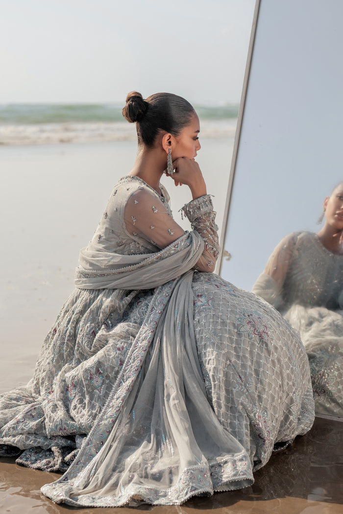 NAQSHI Valeria silver net dupatta draped elegantly, featuring sequin‑line sprays, embroidered luxe pallu border with contrasting hues and delicate floral accents.