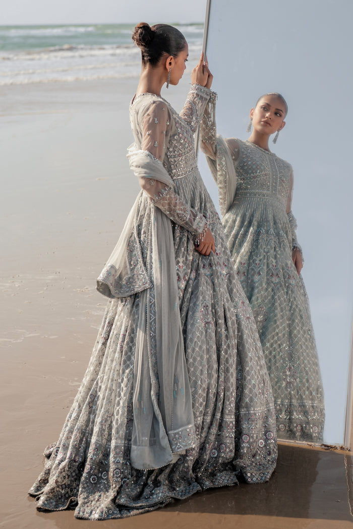 Valeria silver net dupatta draped elegantly, featuring sequin‑line sprays, embroidered luxe pallu border with contrasting hues and delicate floral accents.